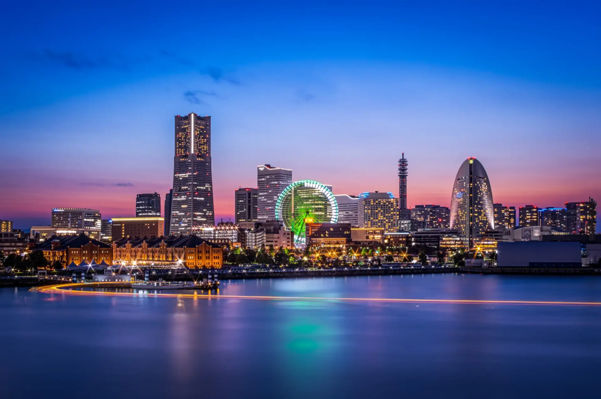 Night view of the Yokohama Minato Mirai skyline across the water.