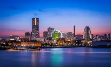 Night view of the Yokohama Minato Mirai skyline across the water.